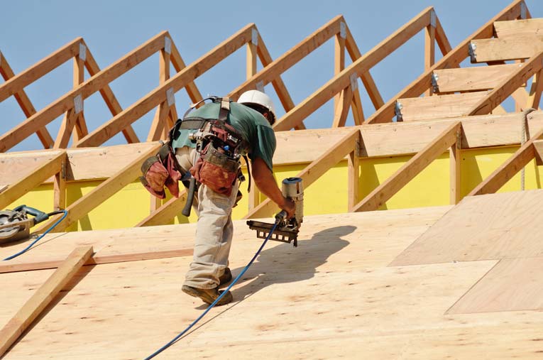 Image of builder working on roof